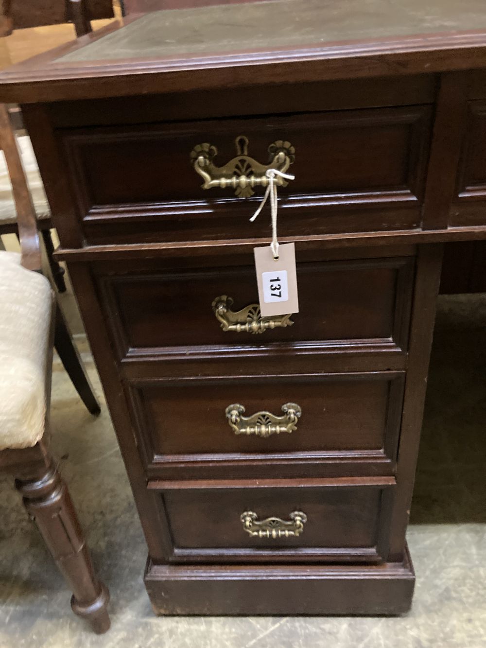 A late Victorian mahogany pedestal desk, stamped J. Shoolbred, width 122cm depth 55cm height 75cm